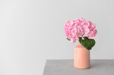 Vase with beautiful hydrangea flowers on table