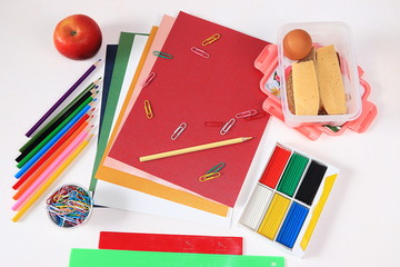 Back to school, Assortment of colored pencils, pens and rulers, juice and school breakfast on a light background, top view. Bright background and colors form extraordinary thinking 
