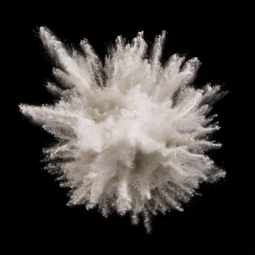 White powder explosion on black background. Freeze motion.