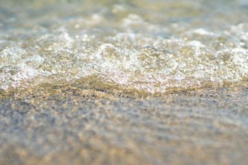 Fototapeta na wymiar close up of a wave rolling onto the beach