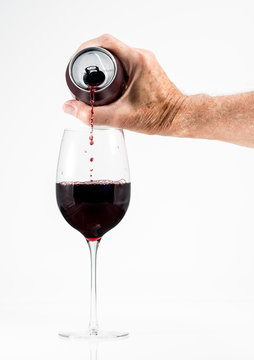 Senior Man Hand Pouring A Glass Of Red Wine From A Single Serving Can