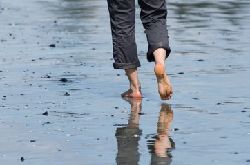 Barefoot female beachgoer  on Chesterman beach