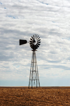 Old Farm Style Water Pumping Windmill. Still Seen Throughout The Rural Farming Areas Of The West Some These Old School Farm Implements Are Still In Use.