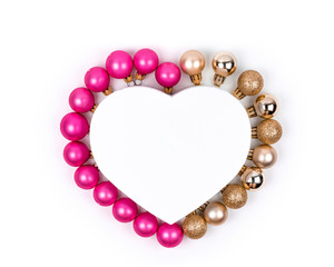 Heart shaped Christmas gift box with  pink and gold Christmas balls with  for holiday, christmas, thanks giving day, birthday top view isolated on white background. 