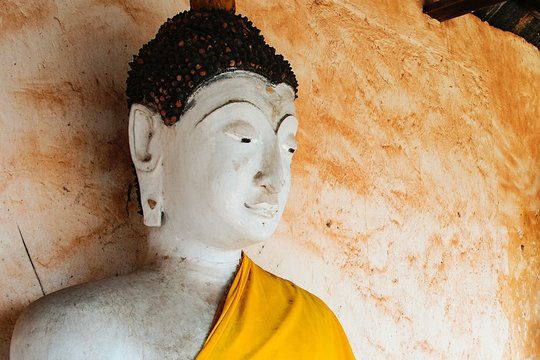 White face of Buddha statue in Buddhist Temple, Ratchaburi Thailand