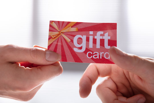 Female Hand Giving Gift Card To Her Partner