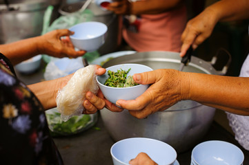 Feeding the poor to hands of a beggar : Concept of famine and social inequality : feeding food for beggar poverty concept : The society of helping to share food to the poor