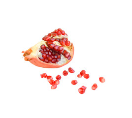 A slice of ripe red pomegranate and pomegranate seeds on a white background, close-up