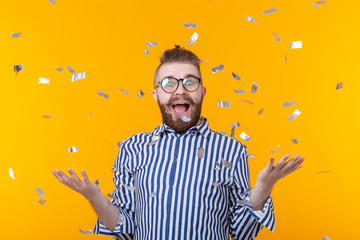 Crazy joyful cheerful young man in a glasses on a yellow background. The concept of a successful party and holiday.