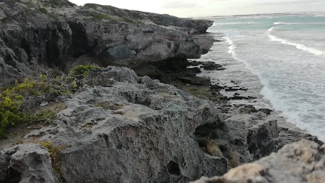 jagged rocks and rocky Sea cliff and waves