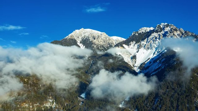 Clouds forming with Piz da Perez mountain peak in the background. Dolomites. Italy.