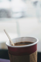 Close up of fresh hot coffee in a paper cup. 
