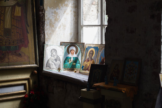 icons with images of saints on the old windowsill in the temple
