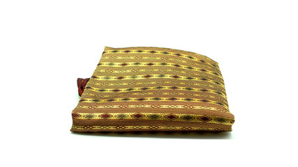 Thai silk woven by hand, placed on a white background.