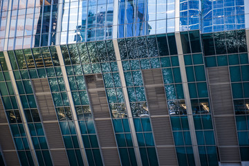The Chicago river reflected on the glass paneling of the skyscraper at 150 North Riverside
