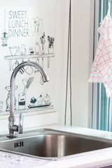 Water tap with sink in modern kitchen.