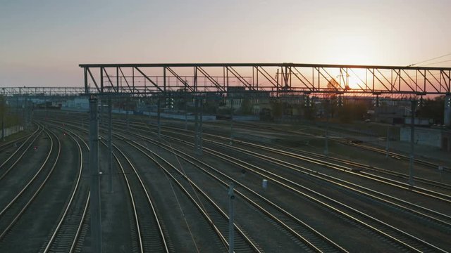 Timelapse shot of a set of empty train tracks against the setting sun. The concept of Simferopol railway station after the annexation of Crimea by the state of the Russian Federation