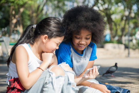 Two girls watching a video on phone together