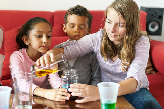 Kids science experiment with colored liquids