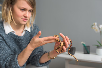 Young caucasian woman defeating her reptile phobia