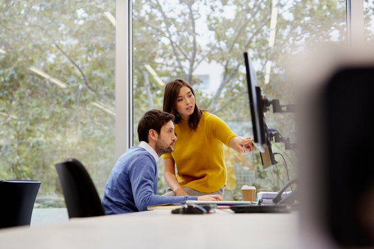Business Colleagues Discussing Over Computer