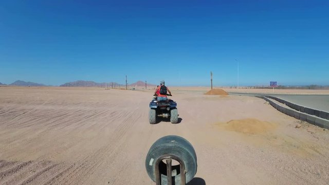 Riding a Quad in the Desert of Egypt. First-person view. Rides ATV bike.