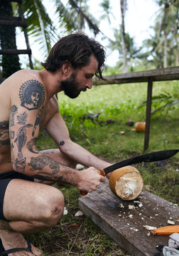 Man opens coconut