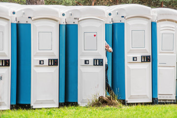 Girl going into portable toilet