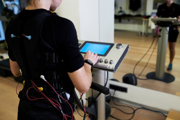 Sportive woman training in electrodes