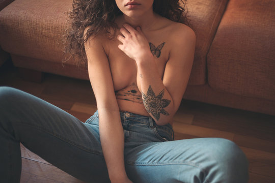 Sensual detail of the body of a tattooed attractive woman