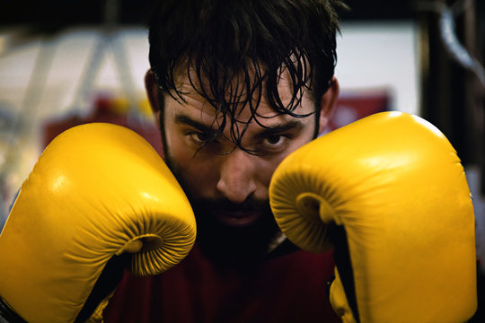 Boxer looking at camera resting in the boxing ring