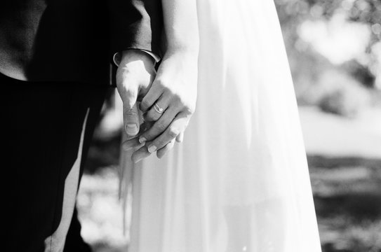 Bride and groom holding hands