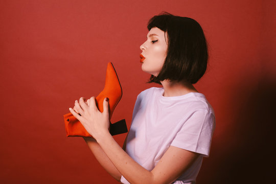 Young stylish woman with red shoe