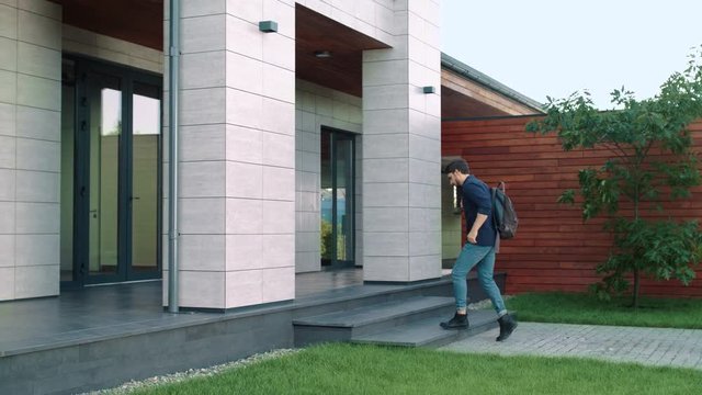 Business Man Entering Office Building With Backpack.