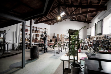 Guitar luthier working in his workshop