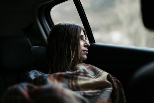 Younger woman thinking and enjoying at travel by car.