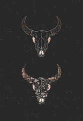Fototapeta premium Vector illustration with two variants of hand drawn bull skulls on black background. Gold silhouettes and contour with grunge texture.