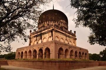 Fototapeta na wymiar The Qutb Shahi Tombs are located in Hyderabad, India and they contain the tombs and mosques built by the various kings of the Qutb Shahi dynasty. They were built between the 16th and 17th centuries.