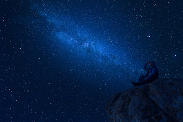 Fototapeta na wymiar Mountaineer look at night sky with stars