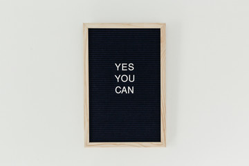 Spring Come Soon"" written on a letterboard hanging on the wall