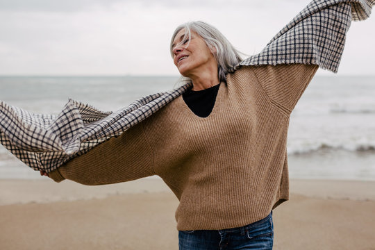 Senior woman enjoying a winter day on the beach.