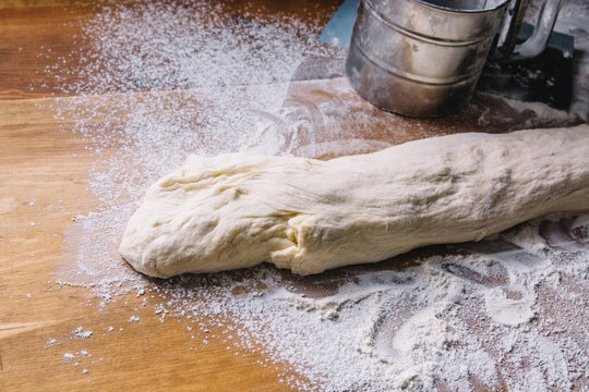 Shaped French baguette dough on a wooden table