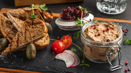 Liver pate with onions in a  bowl. Tasty appetizer in a glass bowl