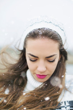 Young woman with white sweater and hat winter portrait