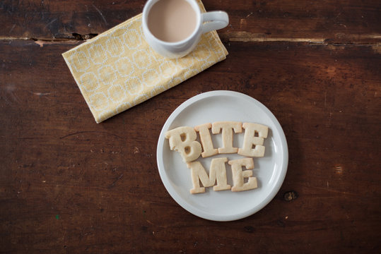 Shortbread Cookie Letters spelling out the words ""bite me"" during a tea break
