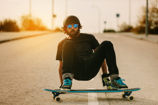 Young Man Longboarding in the Street