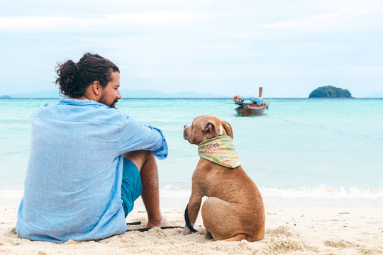 Dog and a man at the beach