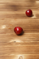 Red sweet cherry scattered on a wooden table
