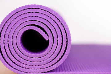 Naklejka premium close up of yoga mat on the table, sport and healthy concept