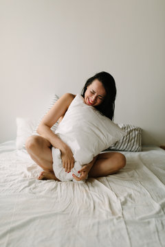 happy naked woman on the bed